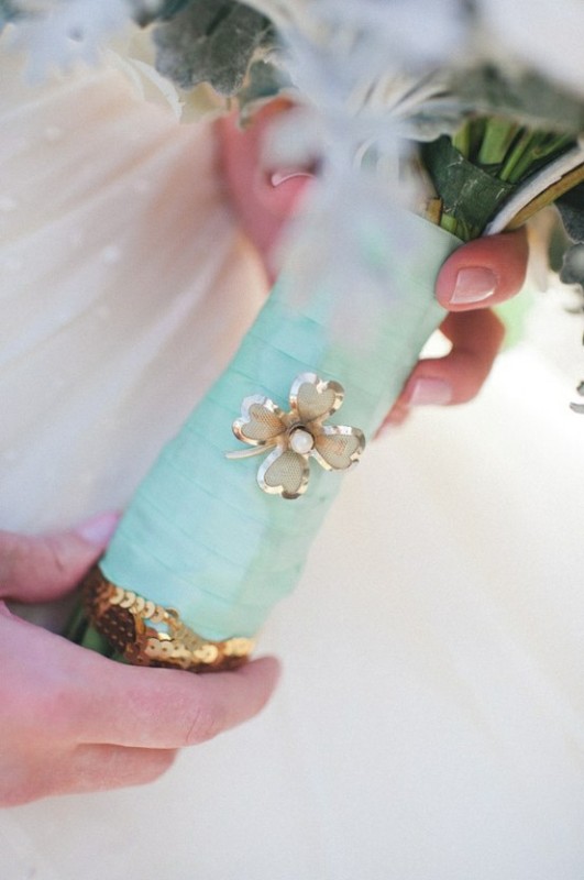 A mint ribbon bouquet wrap and a floral brooch to highlight the wedding bouquet decor