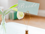 a mint seating card on a stone stand with wire is a cool idea to mark the place setting