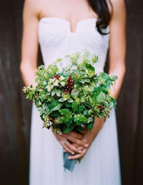 a simple emerald greenery bouquet with berries and wildflowers for a bride