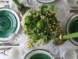 emerald botanical plates and emerald candles to spruce up a neutral tablescape