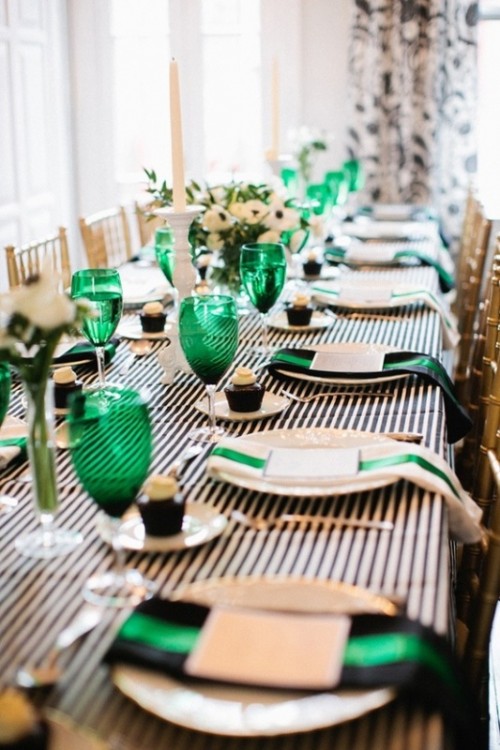 emerald glasses and black and emerald napkins add color to this monochromatic table setting