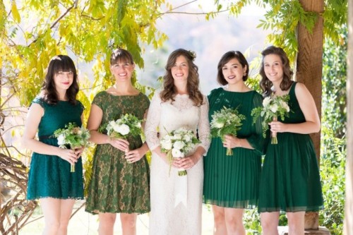 mismatching emerald and printed bridesmaid dresses over the knee for a fall wedding