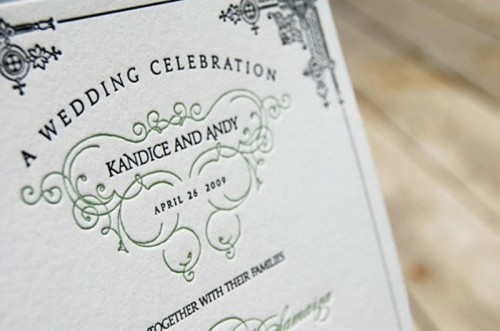 a wedding invite decorated with emerald patterns and calligraphy