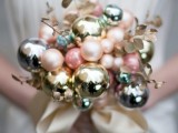 a holiday wedding bouquet fully made of Christmas ornaments and gold foliage plus a neutral ribbon for a New Year or Christmas bride