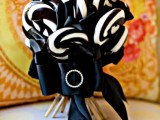 a Halloween weding bouquet made of black and white candy canes and accented with a black ribbon bow