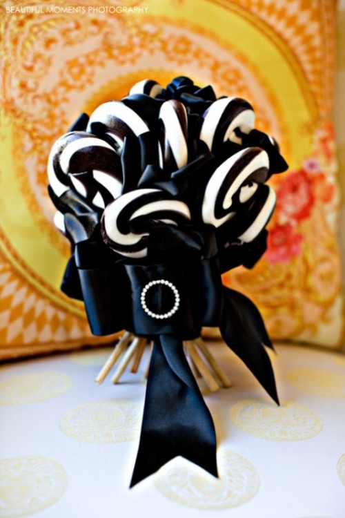 a Halloween weding bouquet made of black and white candy canes and accented with a black ribbon bow