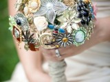 a chic and bold vintage brooch and button wedding bouquet with a wrap is a unique idea
