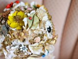 a bright and colorful brooch wedding bouquet in various colors with leaves and flowers is a refined option for a bride