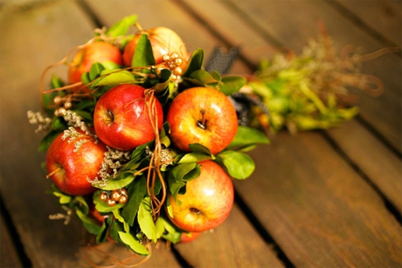An apple and greenery wedding bouquet is a fun idea for a fall bride