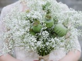 a unique wedding bouquet with baby’s breath and some seed pods is a creative idea