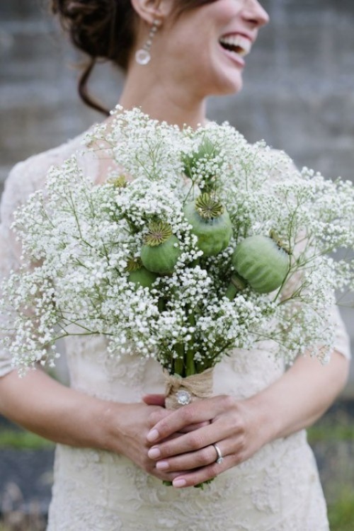 a unique wedding bouquet with baby's breath and some seed pods is a creative idea