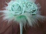a mint green wedding bouquet of fabric blooms, pearls and feathers is a chic idea