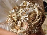a sophisticated gold and white brooch wedding bouquet with pearls, beads and embellished flowers
