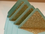 green envelopes with gold glitter lining are amazing for a modern glam wedding, such a combo of colors is lovely
