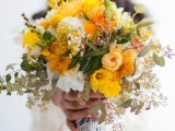 a bold yellow wedding bouquet with white blooms, greenery, billy balls and eucalyptus is a cool option for spring