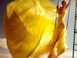 a bold yellow draped dress with a train and a capelet is a daring idea for a spring or summer bride