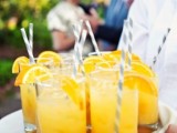 bold yellow lemonade with citrus slices are a great idea of a refreshing drink at a spring wedding
