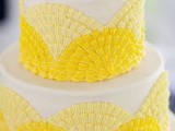 a bold wedding cake with light and bright yellow textural patterns is a cool solution to rock