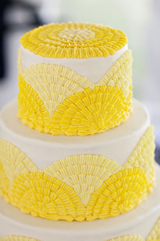 A bold wedding cake with light and bright yellow textural patterns is a cool solution to rock