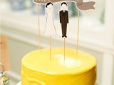 a bold one tier yellow wedding cake with simple toppers is a lovely idea with much color