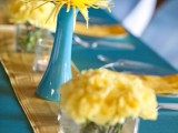 bold yellow blooms in vases and yellow linens will accent your spring wedding tablescape