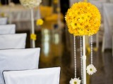 bold yellow topiaries with beads and blooms to decorate a wedding venue or an aisle