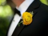a black tux and a bold yellow boutonniere for an elegant and chic look at the wedding