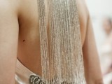 a stunning necklace with long shiny silver fringe that accents the open back and makes a fashion statement