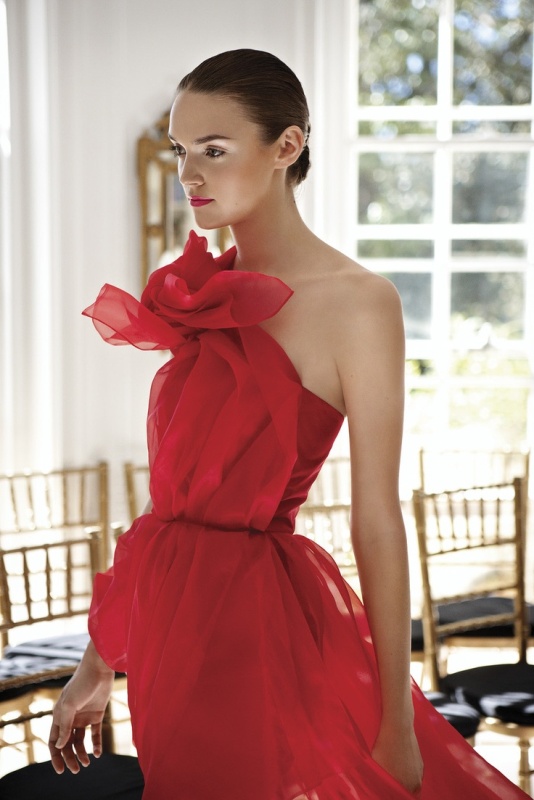 A hot red wedding dress with a layered bodice that forms a giant flower is a bold statement to rock