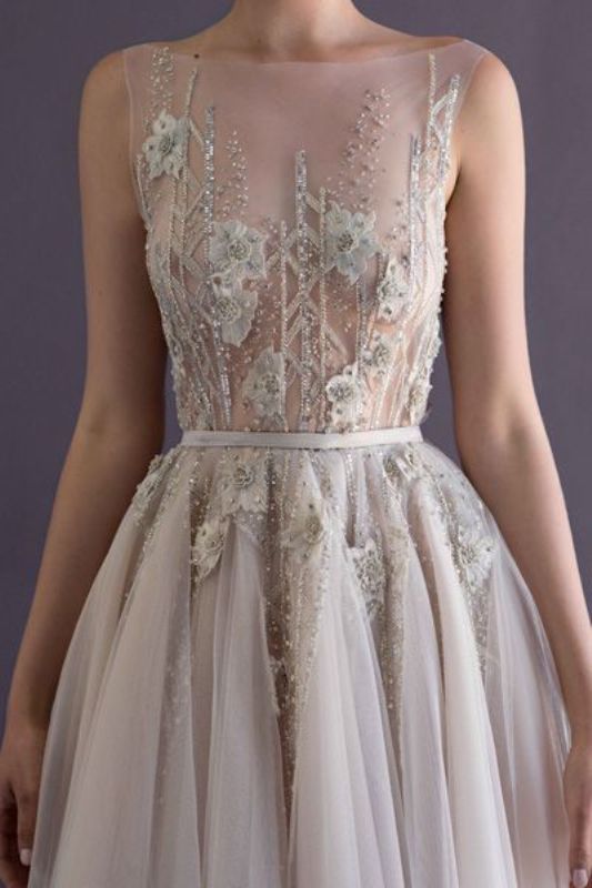 A beautifully embellished and embroidered wedding dress with floral appliques placed strategically