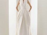a sculptural minimalist wedding dress with a catchy pleated skirt with pockets is a very daring and bold solution