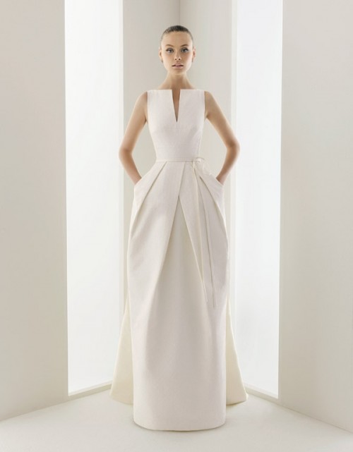 a sculptural minimalist wedding dress with a catchy pleated skirt with pockets is a very daring and bold solution