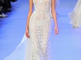 a semi sheer lace embellished sheath wedding dress with a sculptural bodice and a train is a lovely and very glam idea