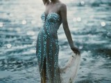 a strapless mermaid-inspired fully embellished wedding dress with a small train for a lovely beach bridal look