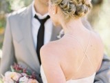 a braided updo with a messy top is an elegant and chic wedding hairstyle to try