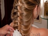 a large dimensional braid going down with a bloom in the end is a unique idea for long or medium length thick hair