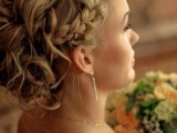 a wavy updo with a messy feel and a braided halo is a creative idea with much texture