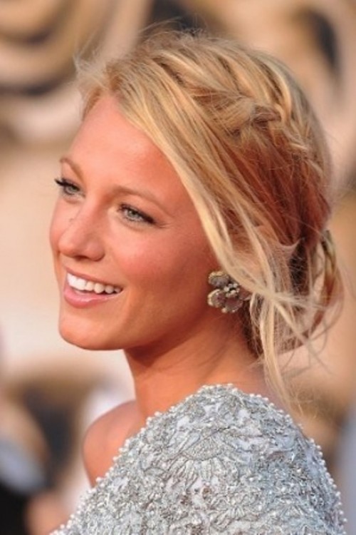 a messy updo with a braid on top is a cool effortlessly chic hairstyle for a bride