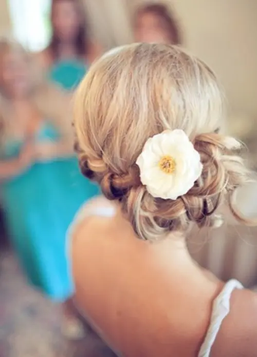 a low braided side updo with a single bloom is a chic and timeless idea that fits most of bridal styles