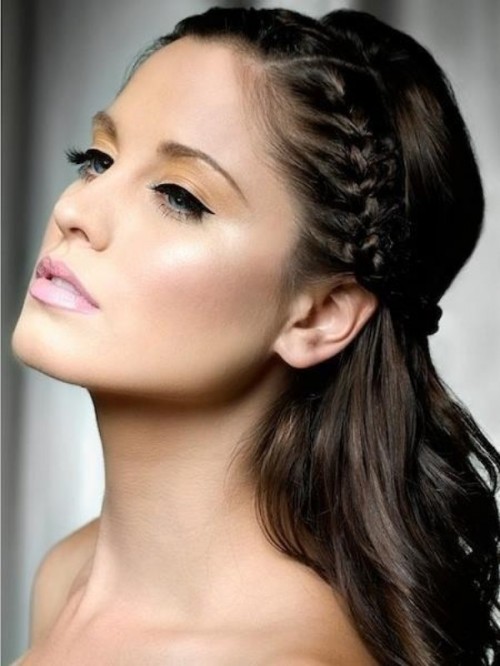 a half updo with wavy hair and a braided halo is a cool idea for a bride or bridesmaid
