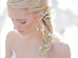 a messy fishtail braid with baby’s breath tucked in for a more relaxed and boho chic look