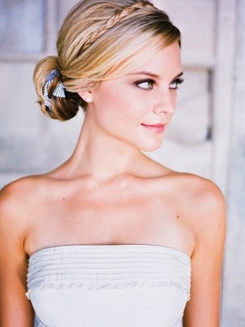 a sleek low bun with a braided halo plus a printed blue ribbon in the bun is a chic and beautiful idea
