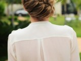 a low updo with a diagonal braid and locks down is an elegant and chic idea