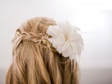 a half updo with a braid and a fresh bloom on top is a chic an simple idea suitable for both medium length and long hair