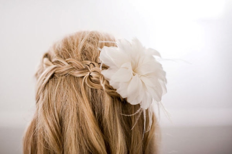 A half updo with a braid and a fresh bloom on top is a chic an simple idea suitable for both medium length and long hair