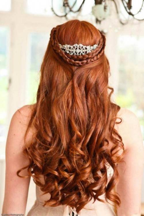 a half updo with a double braid halo, waves and an embellished hairpiece that highlights the braids