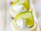delicious mini cheesecakes topped with whipped cream and lime slices for a fresh touch