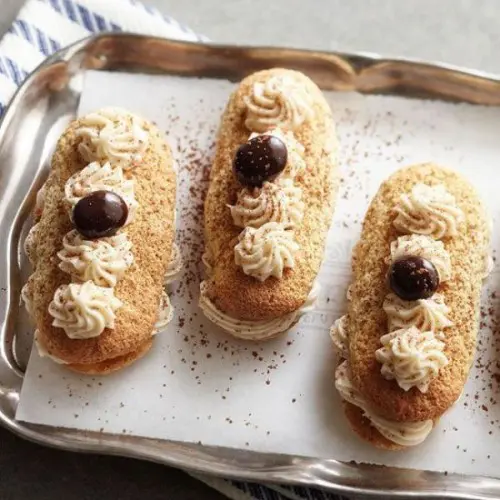 delicious eclairs with cream and cherries on top are a very refined dessert idea
