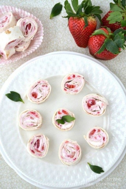 a sweet cream cheese and raspberry roll cake cut in pieces