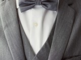a stylish three-piece grey suit, a white shirt and a bow tie compose a timeless groom’s look